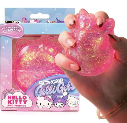 A hand holds a translucent pink cat-shaped gel toy filled with gold glitter, shown next to its retail packaging labeled Hello Kitty and Friends.