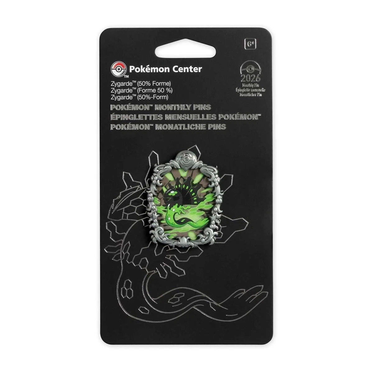 Pokémon Center monthly pin in its original black blister packaging, featuring a Zygate green and silver holographic pin.