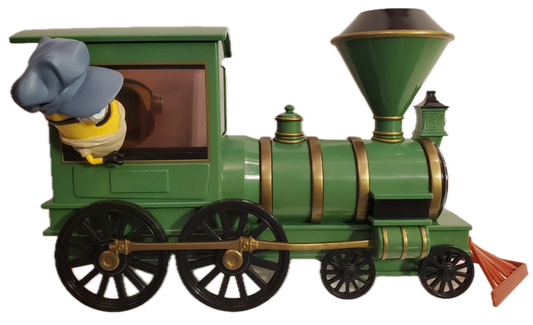 A green toy train engine with gold trim, black wheels, and a cartoon character peeking out from the driver's window, isolated on a white background.