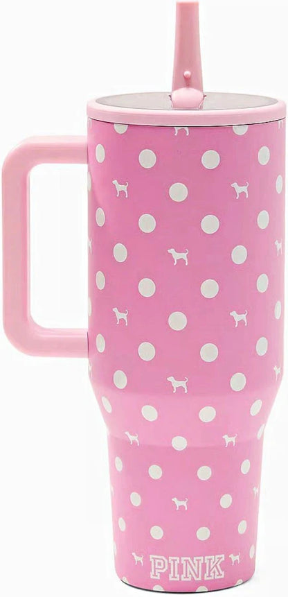 Pink handled tumbler with white polka dots and small dog silhouettes, featuring a matching pink lid and straw, with the word PINK printed near the bottom.