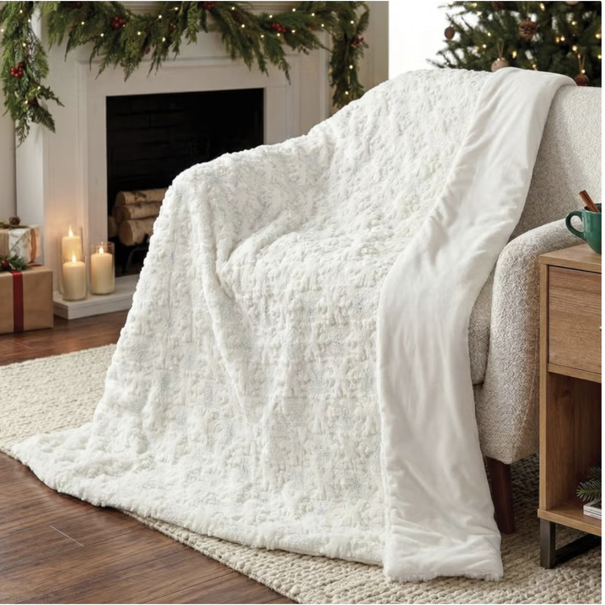 Holiday embroidered faux fur throw, Snowflake style, draped over a chair