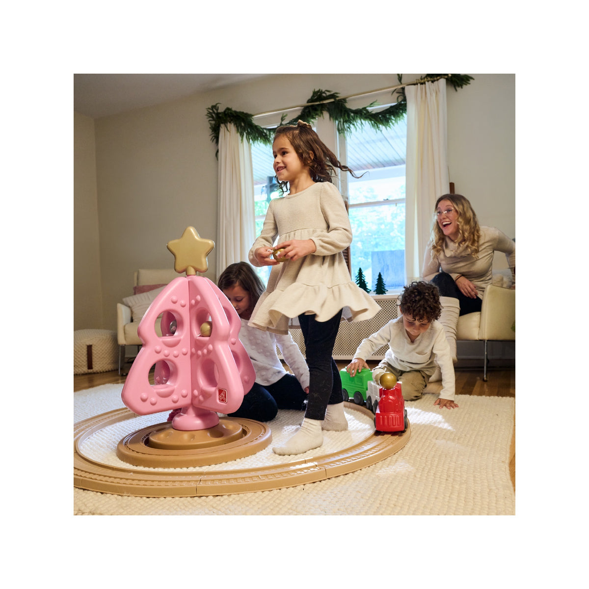 Family playing with the Step2 pink My First Christmas Tree