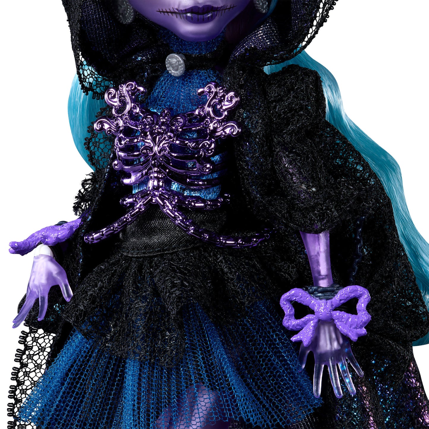Close-up of a doll with purple hands and a decorative purple bow, wearing a black and blue outfit.