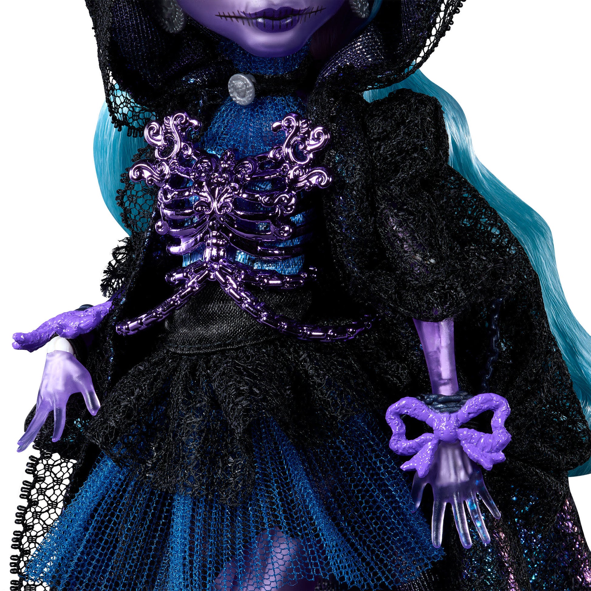 Close-up of a doll with purple hands and a decorative purple bow, wearing a black and blue outfit.